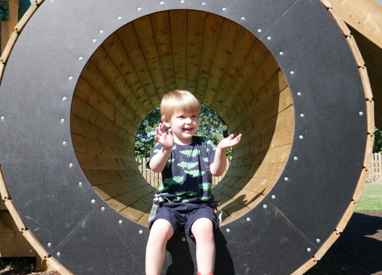 A child in the playground tunnel